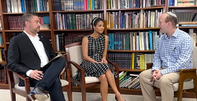 Kevin and commissioner Jerica Richardson sitting down talking with local rabbi