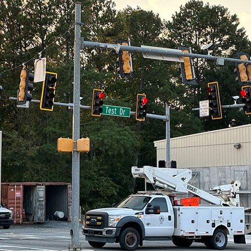 Picture of county vehicle working on traffic lights at an intersection